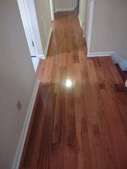 Newly installed hallway flooring with clean transitions and white baseboards